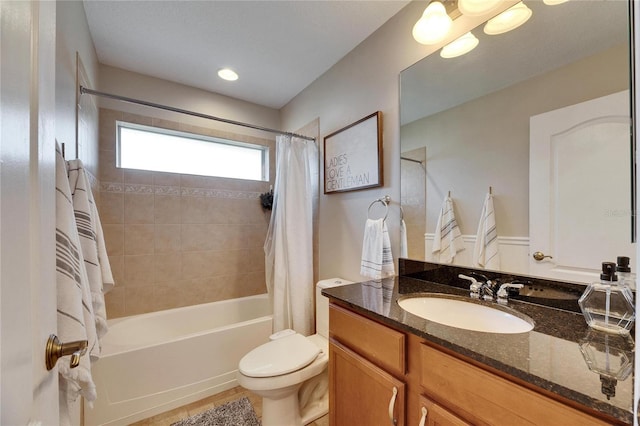 full bathroom featuring shower / bathtub combination with curtain, vanity, and toilet