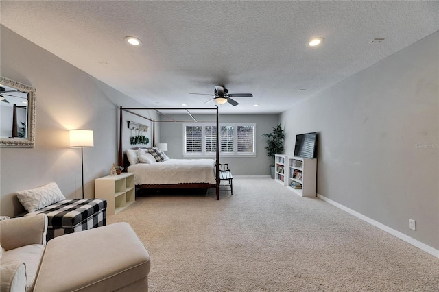 bedroom with light carpet, ceiling fan, and a textured ceiling