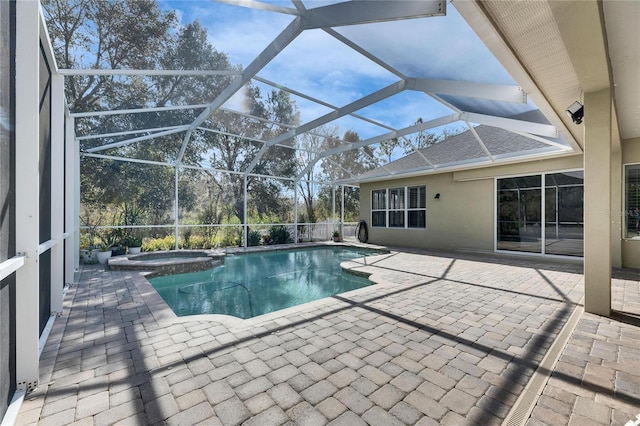 view of swimming pool featuring a patio area, an in ground hot tub, and glass enclosure