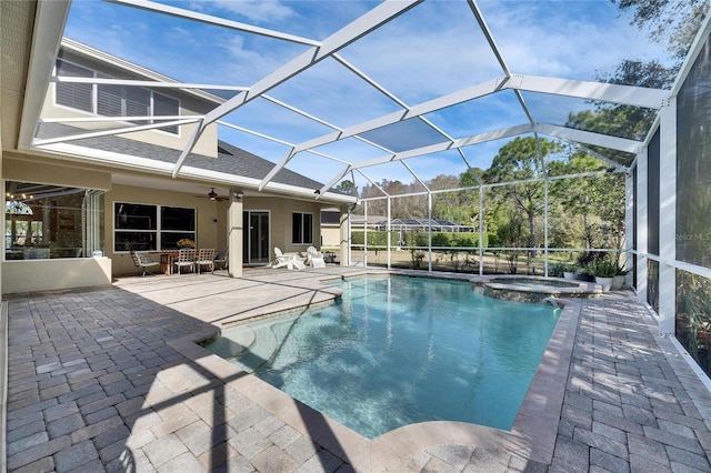 view of swimming pool featuring an in ground hot tub, a patio, and glass enclosure