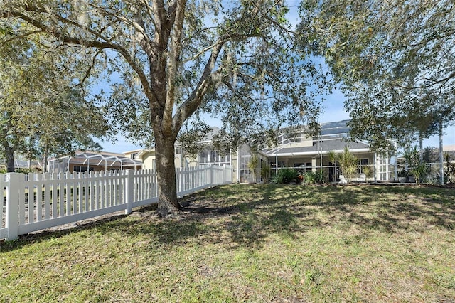 view of yard with glass enclosure