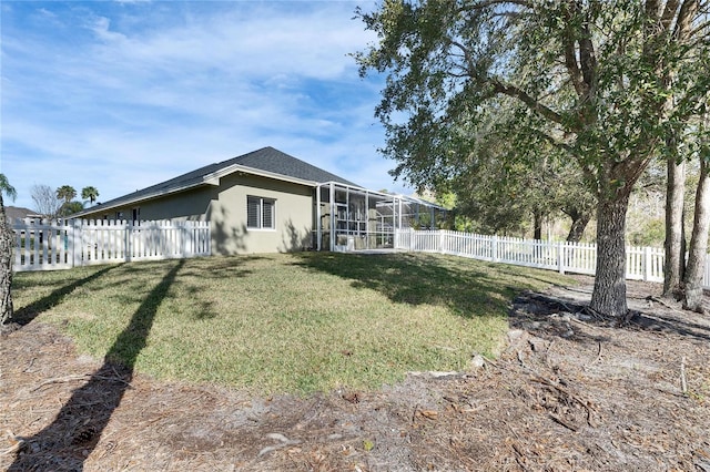 exterior space with a yard and a lanai