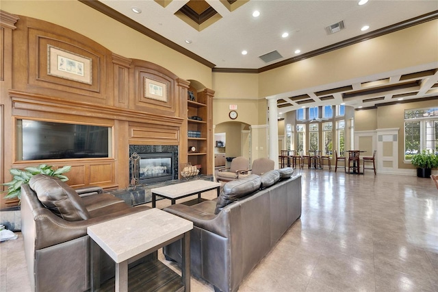 living room featuring ornate columns, crown molding, a high ceiling, and a fireplace