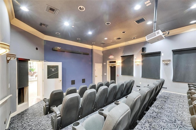 cinema featuring ornamental molding and a towering ceiling