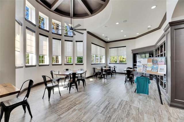 dining space with crown molding, ceiling fan, coffered ceiling, and beam ceiling