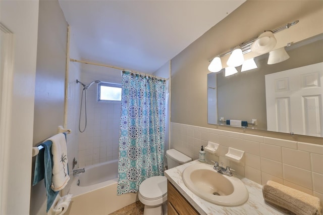 full bathroom with vanity, toilet, tile walls, and shower / bath combo with shower curtain