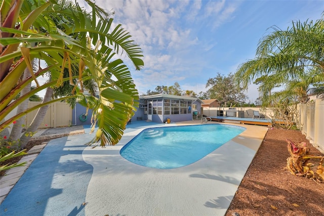 view of pool with a patio and a sunroom