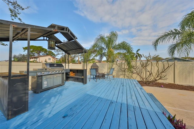 deck featuring exterior kitchen and a patio area