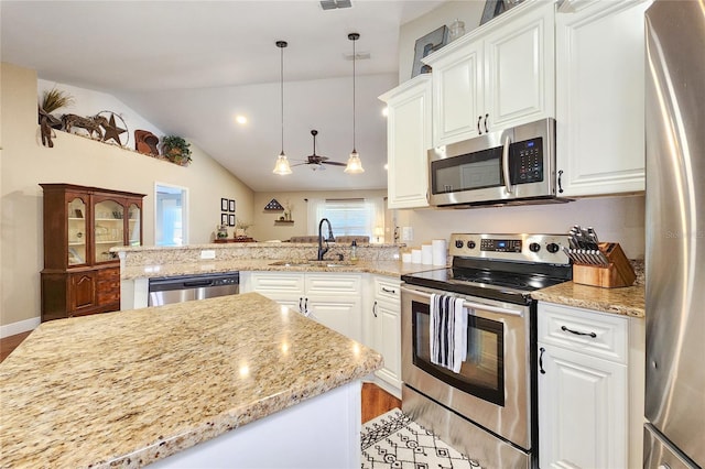 kitchen with pendant lighting, sink, stainless steel appliances, white cabinets, and kitchen peninsula