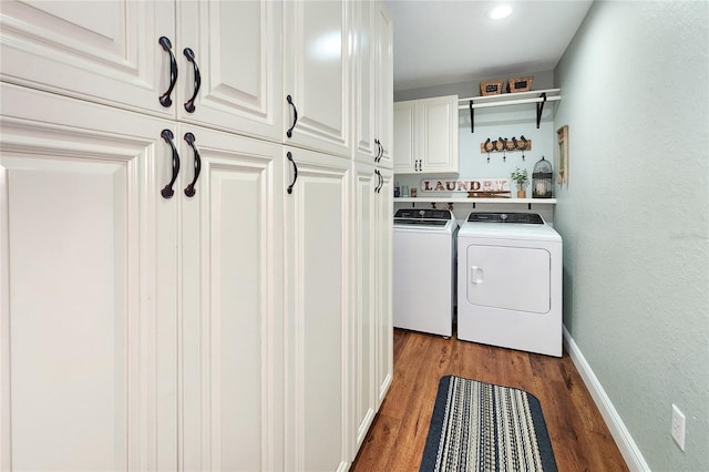 washroom featuring cabinets, dark hardwood / wood-style floors, and separate washer and dryer