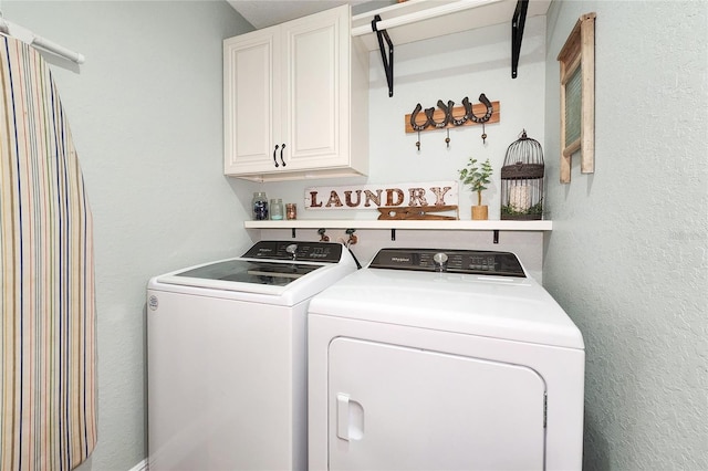 washroom featuring cabinets and independent washer and dryer