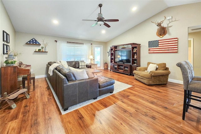 living room with wood-type flooring, lofted ceiling, and ceiling fan