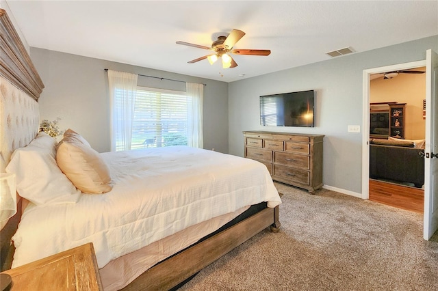 bedroom featuring ceiling fan and light carpet