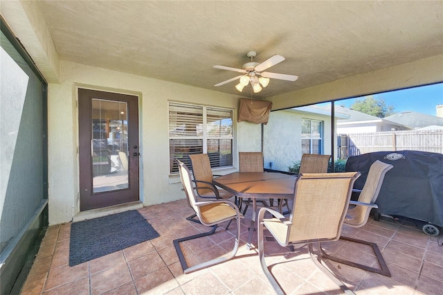 sunroom / solarium featuring ceiling fan