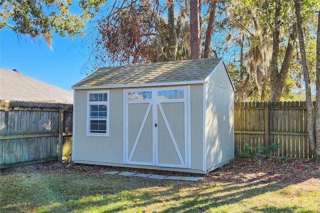 view of outdoor structure featuring a lawn