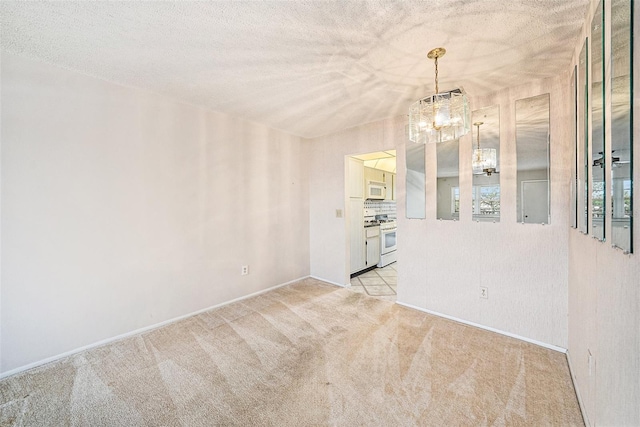 carpeted spare room with a textured ceiling