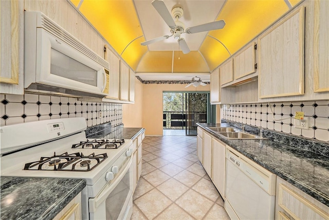 kitchen with light brown cabinetry, sink, light tile patterned floors, white appliances, and backsplash