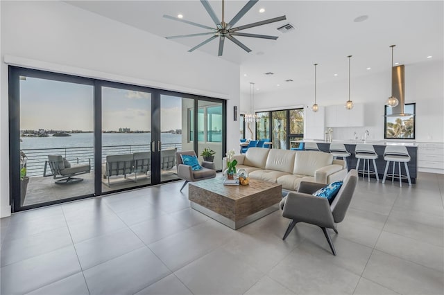 living room with sink, french doors, and a water view