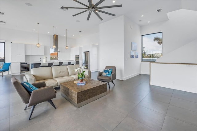 living room featuring a high ceiling and beverage cooler