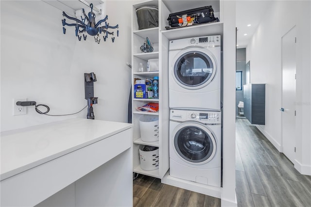 washroom with wood-type flooring and stacked washing maching and dryer