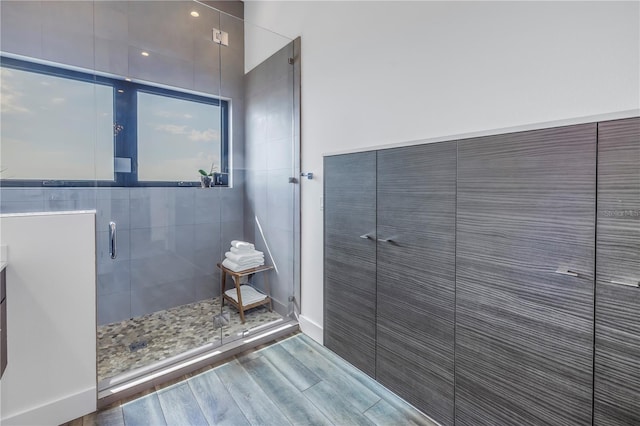 bathroom with an enclosed shower, vanity, and wood-type flooring