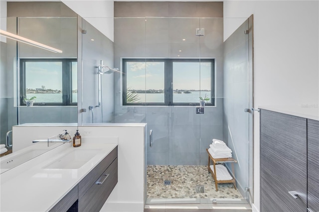 bathroom with vanity, a water view, and walk in shower