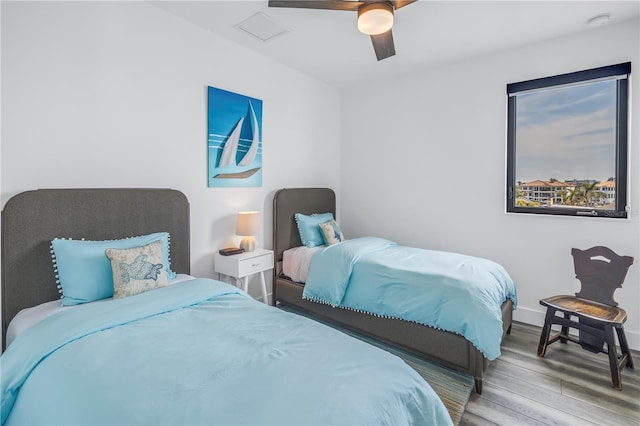 bedroom with hardwood / wood-style floors and ceiling fan