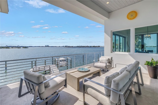 view of patio featuring an outdoor living space, a balcony, and a water view