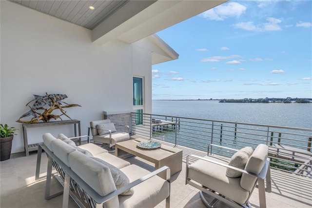 balcony featuring a water view and an outdoor living space