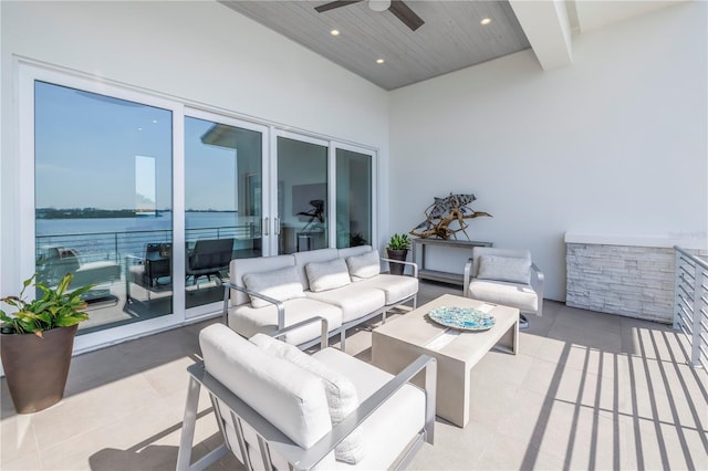 view of patio featuring a water view, ceiling fan, and an outdoor hangout area