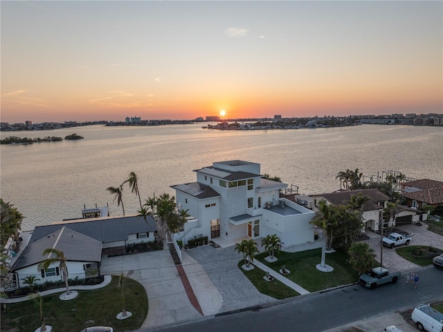 aerial view at dusk with a water view