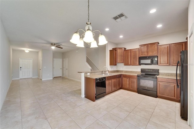 12973 Dream Catcher Way, Riverview, FL 33579 - kitchen with pendant lighting, sink, light stone countertops, black appliances, and kitchen peninsula