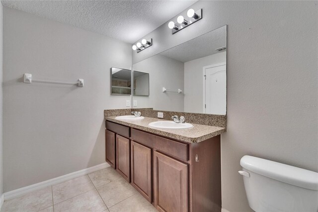 12973 Dream Catcher Way, Riverview, FL 33579 - bathroom with vanity, tile patterned floors, a textured ceiling, and toilet