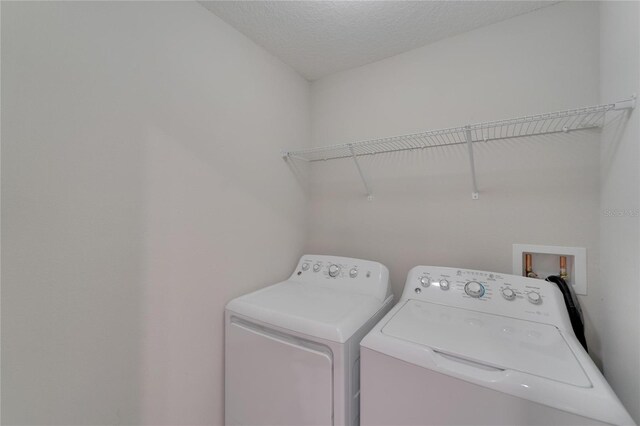 12973 Dream Catcher Way, Riverview, FL 33579 - laundry room featuring washer and dryer and a textured ceiling