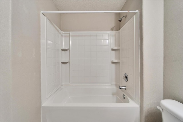12973 Dream Catcher Way, Riverview, FL 33579 - bathroom featuring washtub / shower combination, toilet, and a textured ceiling