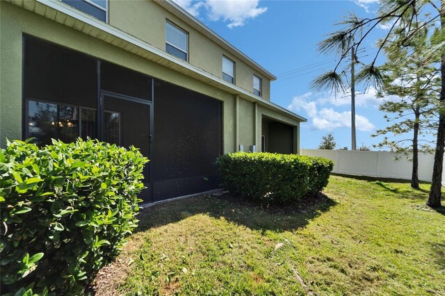 12973 Dream Catcher Way, Riverview, FL 33579 - view of side of home featuring a sunroom and a lawn