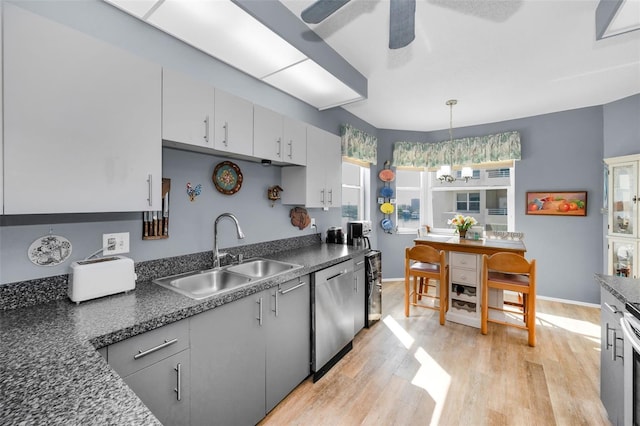 kitchen featuring sink, dishwasher, pendant lighting, ceiling fan, and light hardwood / wood-style floors