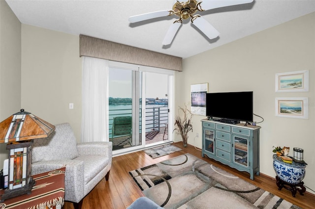 living room with ceiling fan and hardwood / wood-style floors