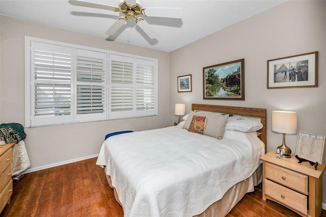 bedroom with dark wood-type flooring and ceiling fan