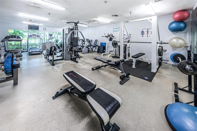 gym featuring a textured ceiling