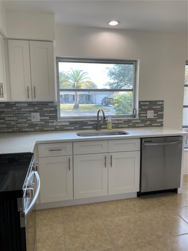 kitchen with white cabinetry, sink, backsplash, and appliances with stainless steel finishes