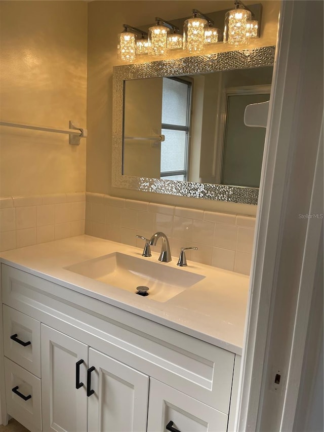 bathroom with tasteful backsplash and vanity