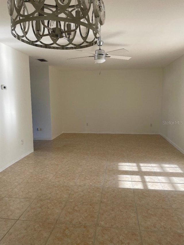 tiled empty room featuring ceiling fan