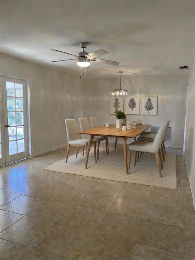 unfurnished dining area featuring light tile patterned floors and ceiling fan