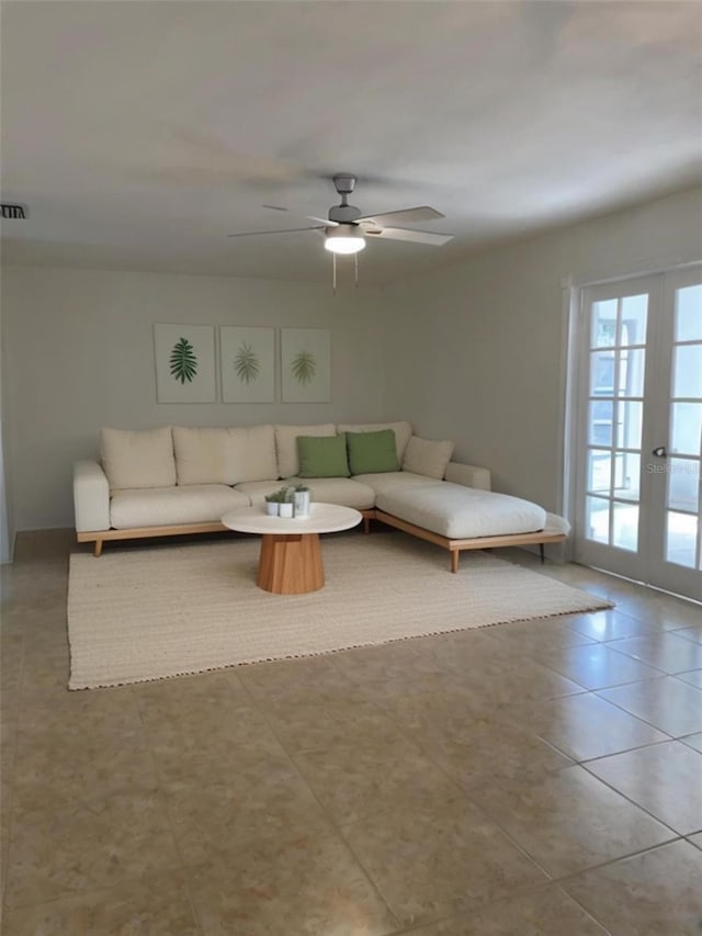 unfurnished living room featuring french doors, ceiling fan, and light tile patterned flooring