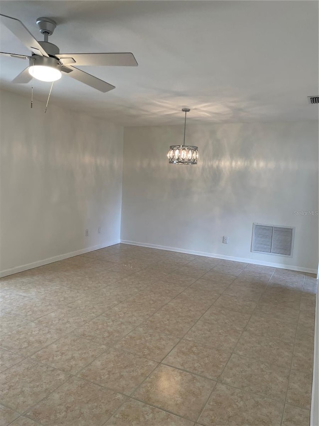 unfurnished room with ceiling fan with notable chandelier