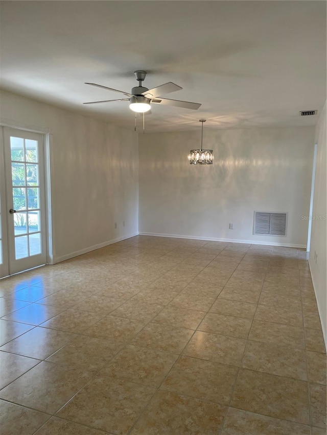 tiled spare room with ceiling fan