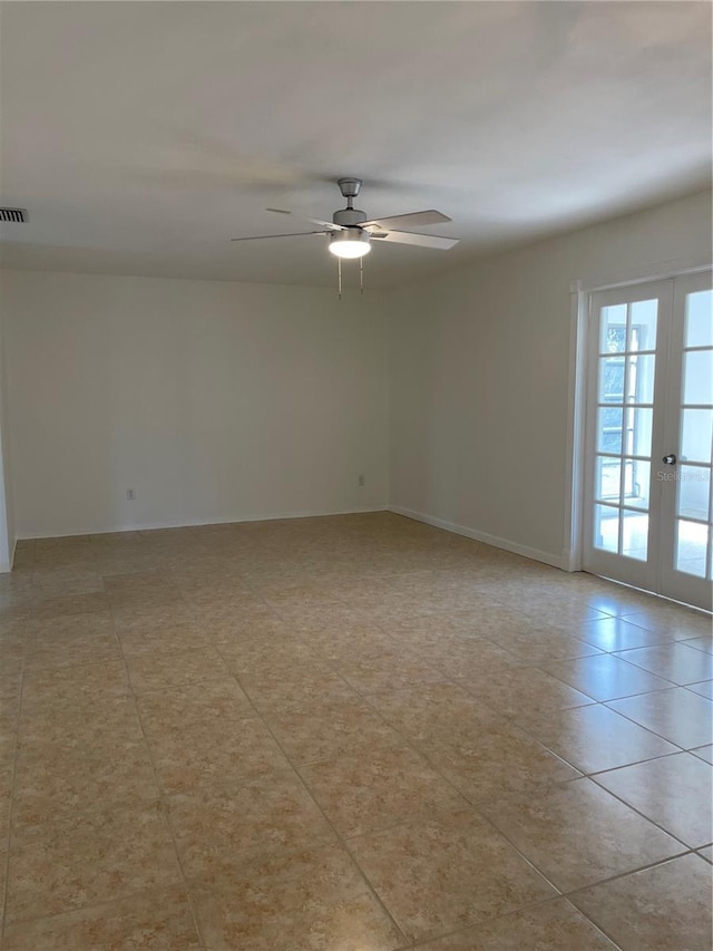 empty room featuring french doors and ceiling fan