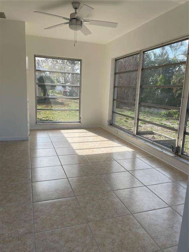 interior space with ceiling fan