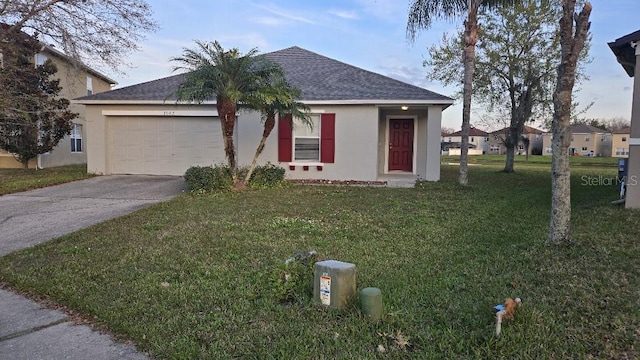 single story home with a garage and a front yard